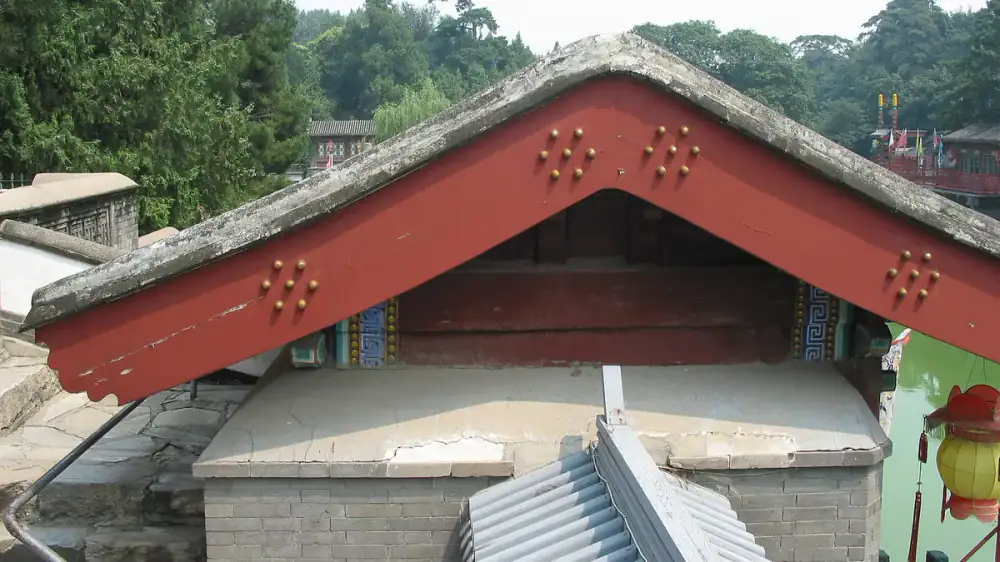 Side-by-side comparison of wood fascia board and aluminum-covered fascia on a roof edge