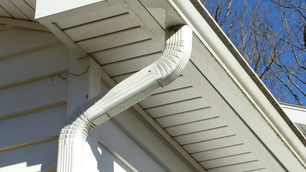 A continuous seamless gutter run following the roofline of a suburban home