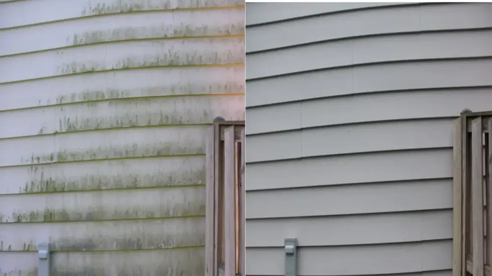 High-pressure water stream directed at the exterior siding of a house