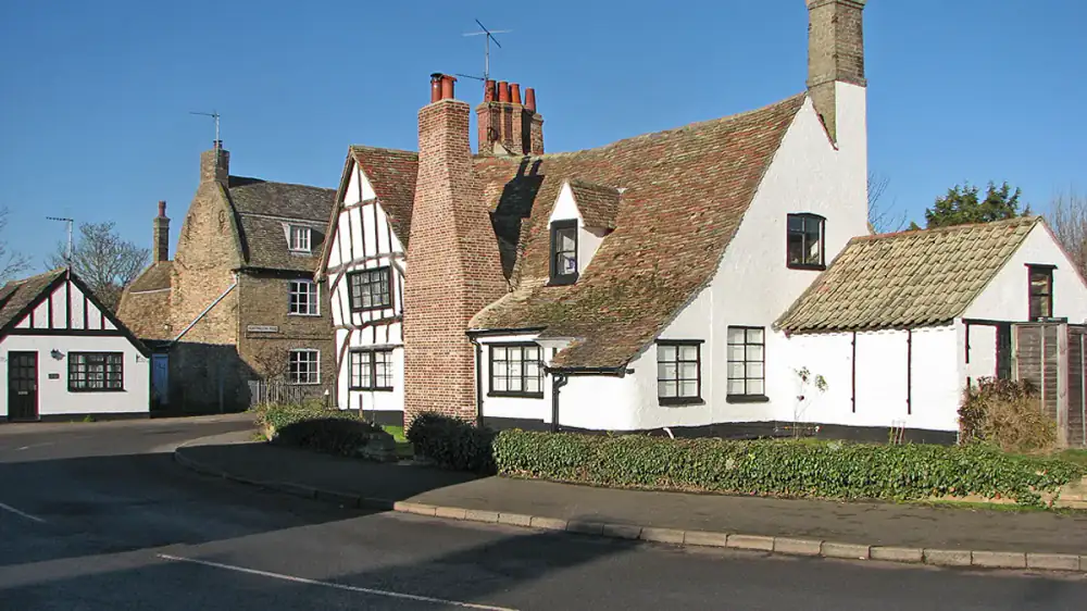 Two rooftop chimneys, one on a home with an active fireplace and one decorative