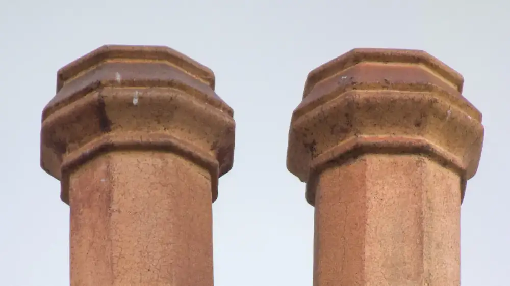 Cross-section view of a masonry fireplace showing the flue passage and a metal damper plate above the firebox