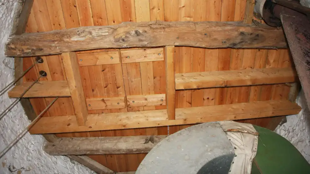 Dark water stains spreading across the underside of a home's soffit