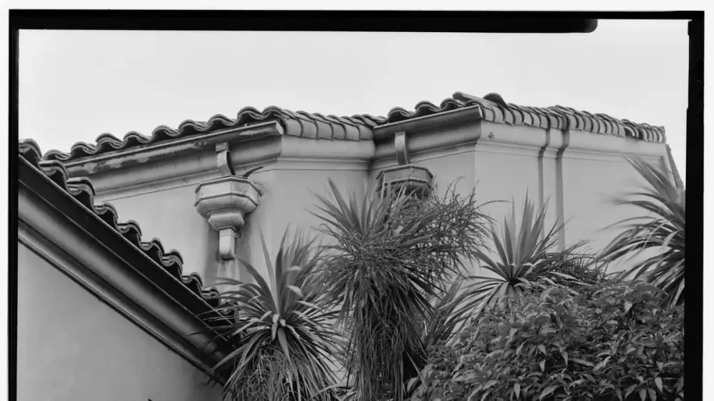 A downspout extension directing roof water away from a home's foundation