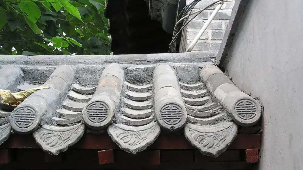 Underside of a roof eave showing damp soffit boards and signs of moisture