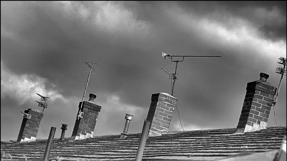White chalky efflorescence staining the brick of a masonry chimney