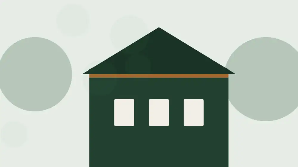 A homeowner looking up at the exterior of a house on a clear day