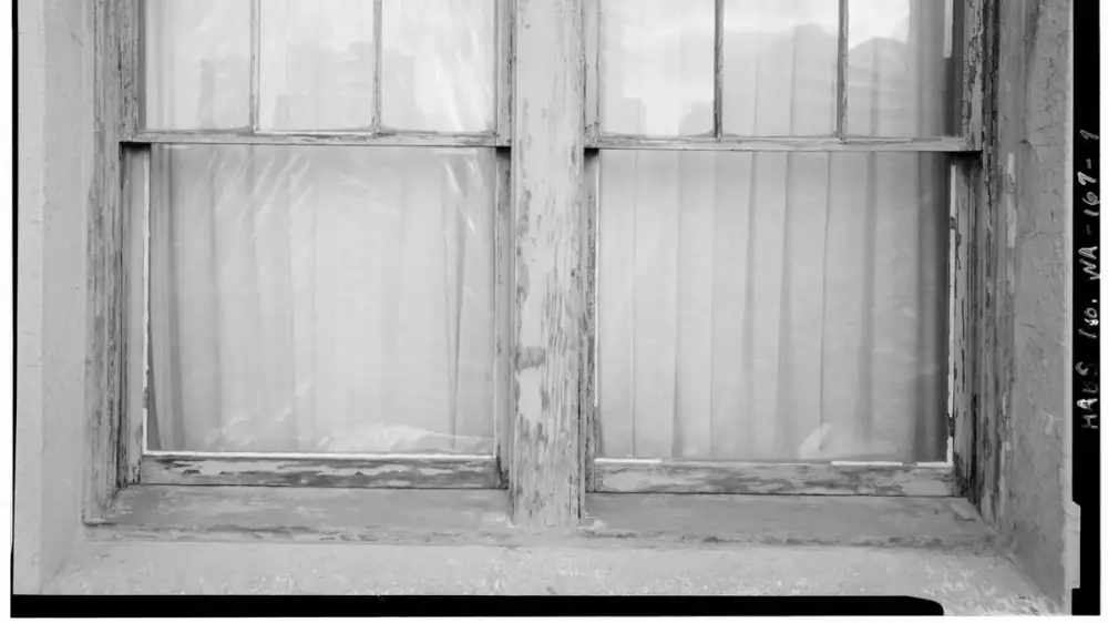 Cracked caulk and an open gap along the trim beside an exterior window