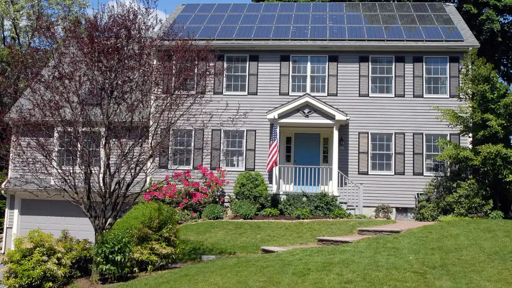 Solar panels on a sloped roof above a gutter fitted with a guard
