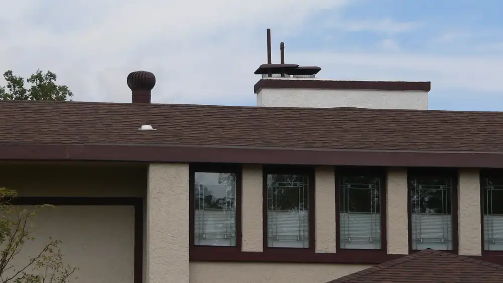 Cross-section view of a roof edge showing shingles, drip edge, gutter, fascia and soffit