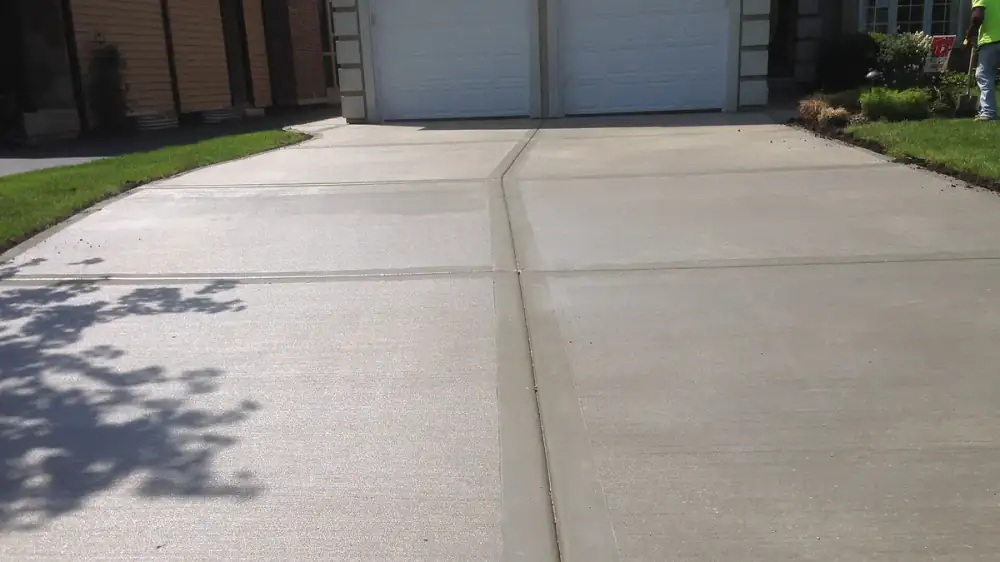 Clean concrete driveway being washed with even, overlapping passes