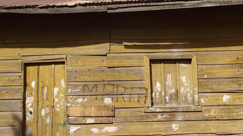 A house exterior showing the effects of sun, rain, and weather over time