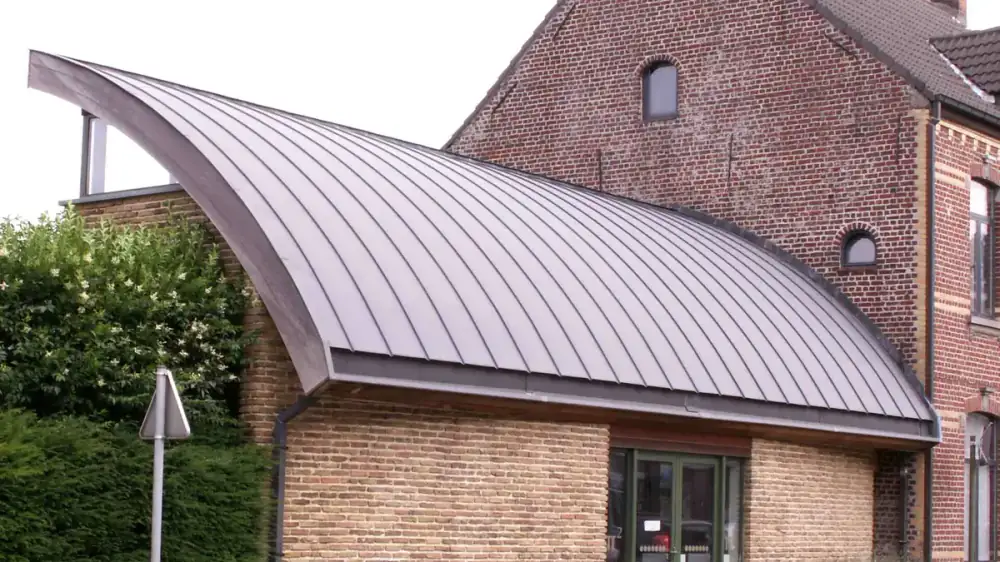 A K-style gutter and a half-round gutter shown side by side along a roof edge