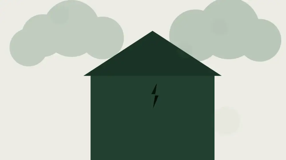A home exterior and roof edge viewed from the ground after a passing storm