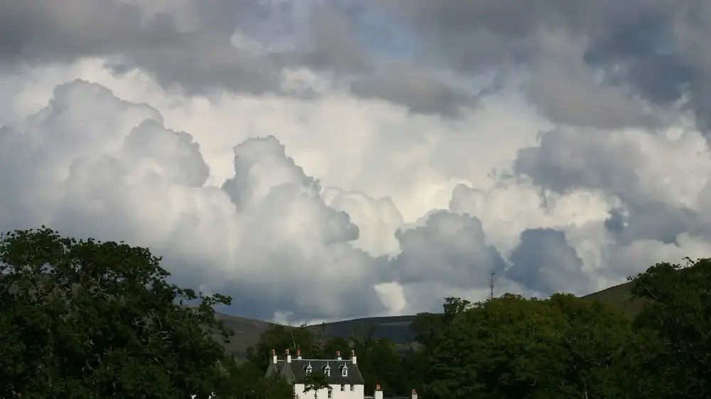 A home's exterior under a darkening sky as a major storm approaches