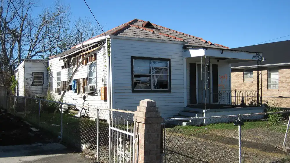 Vinyl siding panels waving and buckling along the side of a house