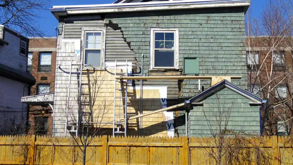 Side-by-side of natural wood siding and low-maintenance vinyl siding on homes