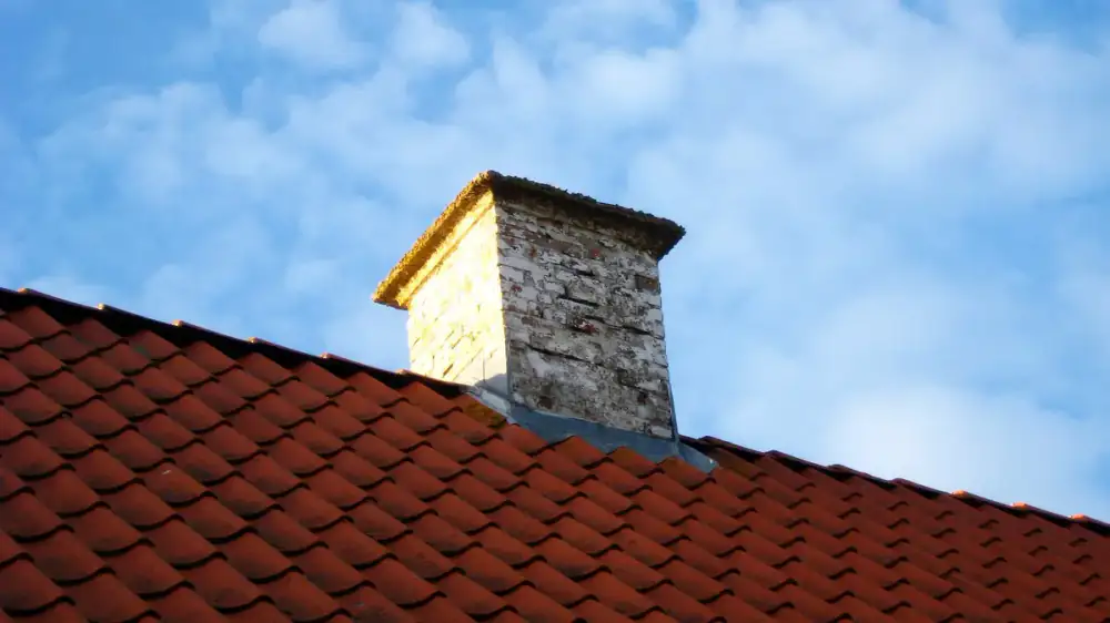 A chimney professional examining a flue with an inspection camera