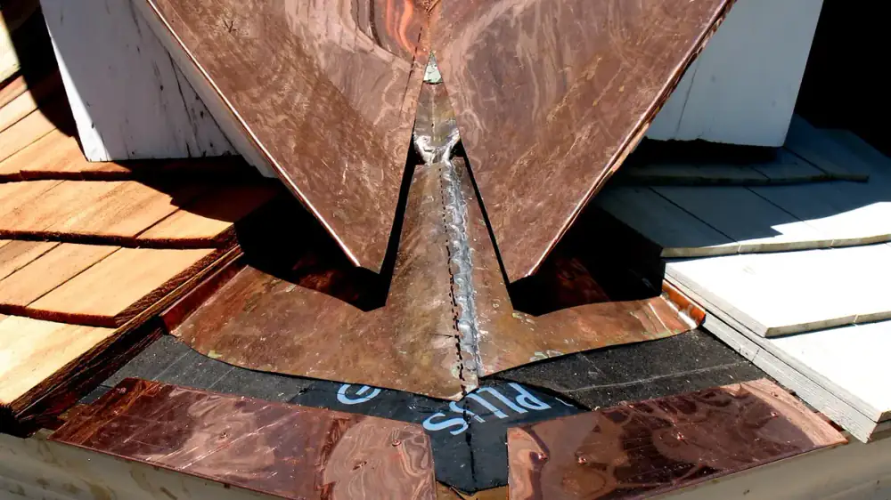Metal drip edge flashing installed along the edge of a roof above a gutter