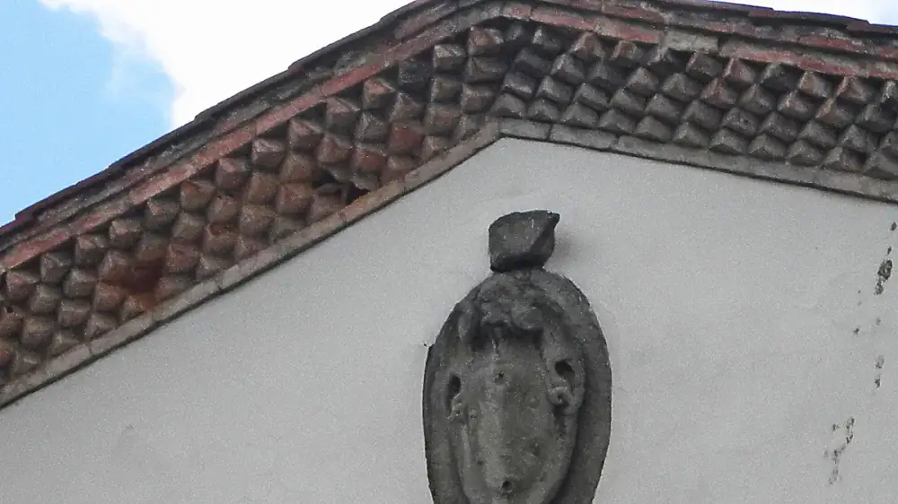 A clogged gutter overflowing, illustrating how one failure cascades into several exterior problems